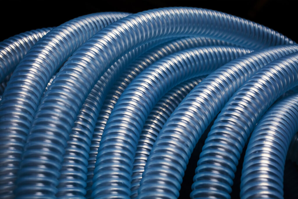 Coils of blue Superflex spiral-reinforced flexible hose